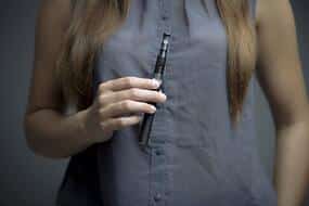 woman holding vape pen