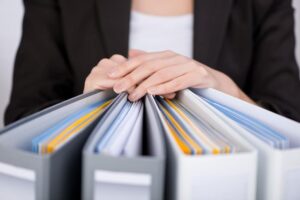 Woman with hands on binders