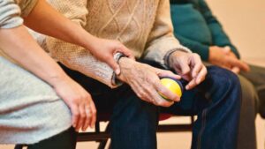 Man holding ball sitting down