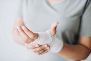 Man holding hand wrapped in bandages