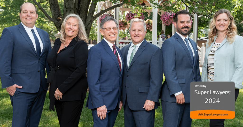 attorneys Kyle Melling, Ellen Hirshman, James Lowe, Ryan Fisher, Scott Kuboff and Meghan Connolly pose outside with a text overlay "Super Lawyers 2024"