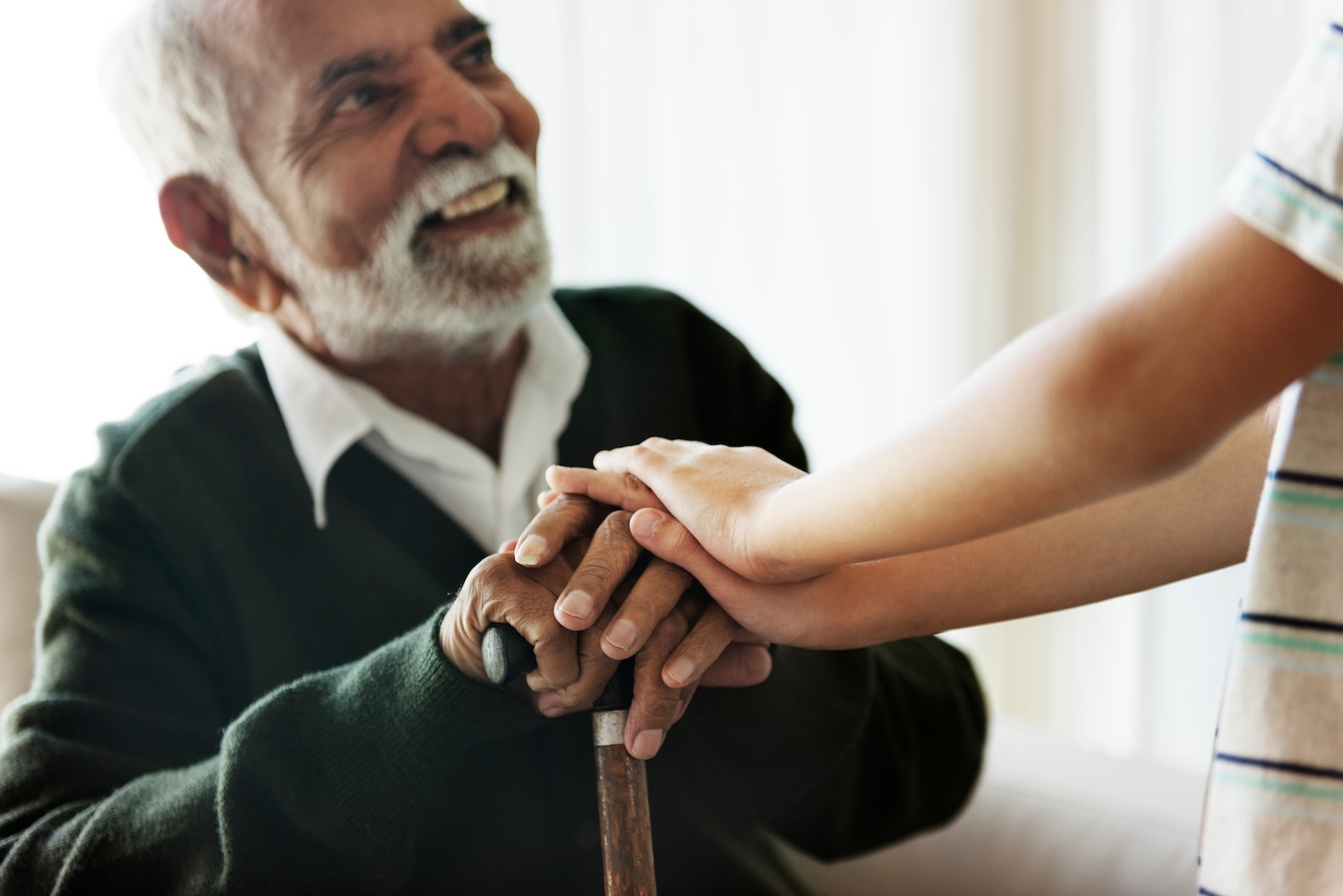 Older man with can smiling at child