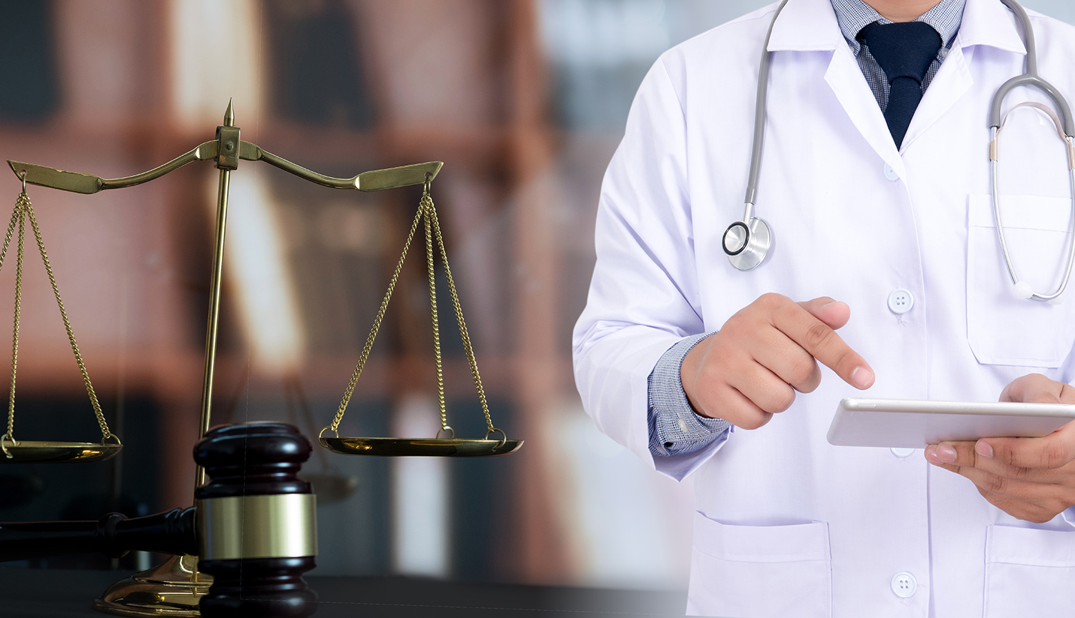 Doctor holding tablet wearing lab coat and stethoscope