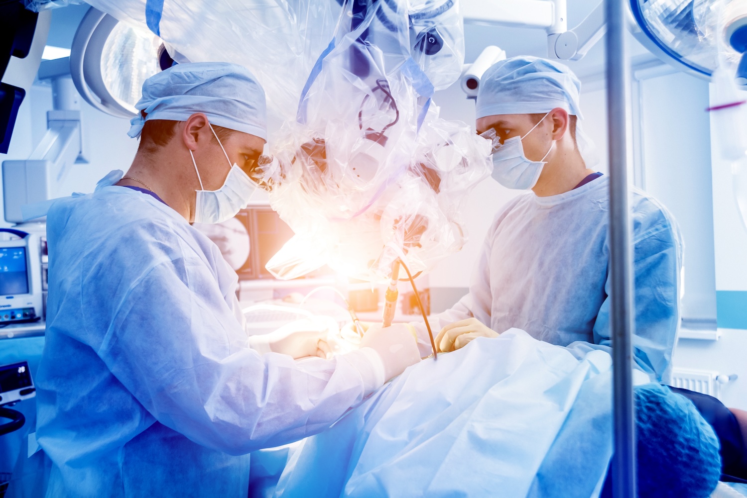 Surgeons operating in room