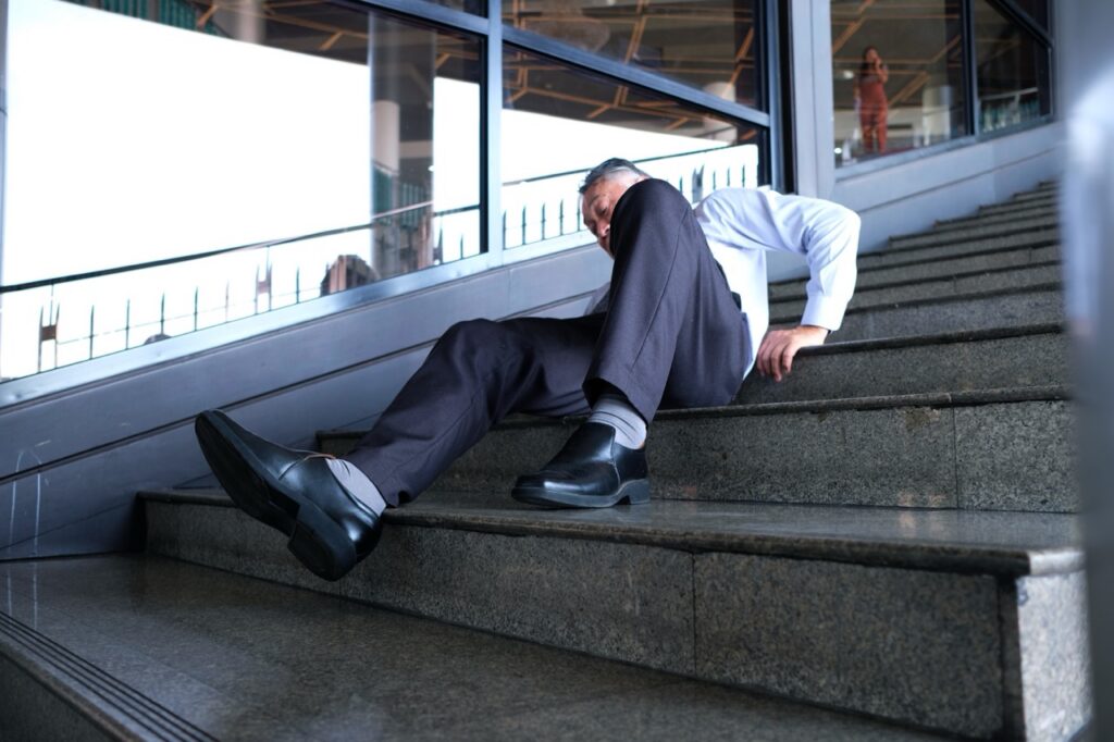 A man falls down the stairs and is injured.