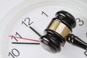 A judge's gavel resting on a clock face, symbolizing legal deadlines and the statute of limitations for personal injury claims in Ohio.